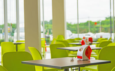 Close-up of chairs and tables in restaurant