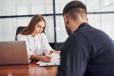 Young woman using laptop at office