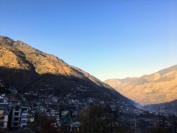 Scenic view of mountains against clear blue sky