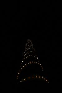 Low angle view of illuminated building against sky at night