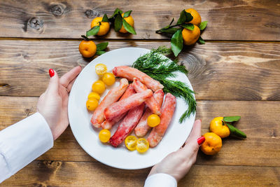 High angle view of person holding food on table