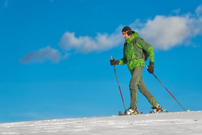 Low angle view of man skiing on snow