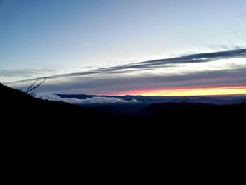 Scenic view of silhouette mountains against sky at sunset