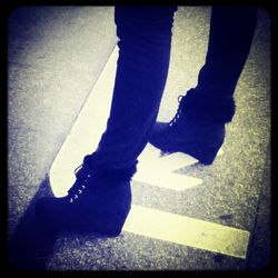 Low section of woman standing on tiled floor