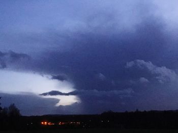 Scenic view of dramatic sky over silhouette trees