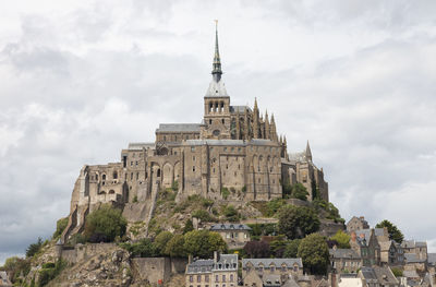 Low angle view of historical building against cloudy sky