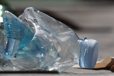 Close-up of crumpled water bottle on table