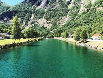 Scenic view of lake amidst trees and buildings