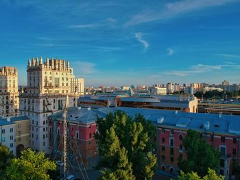 High angle view of buildings against blue sky