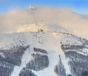 Snow covered landscape against sky