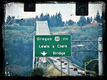 Information sign on road seen through glass window