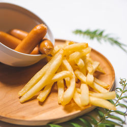 Close-up of burger and fries in plate on table