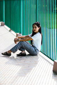 Portrait of woman sitting on fioor.