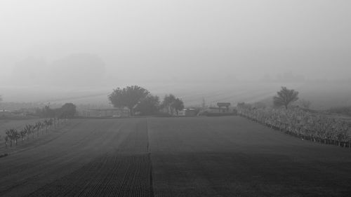 Scenic view of landscape against sky during foggy weather