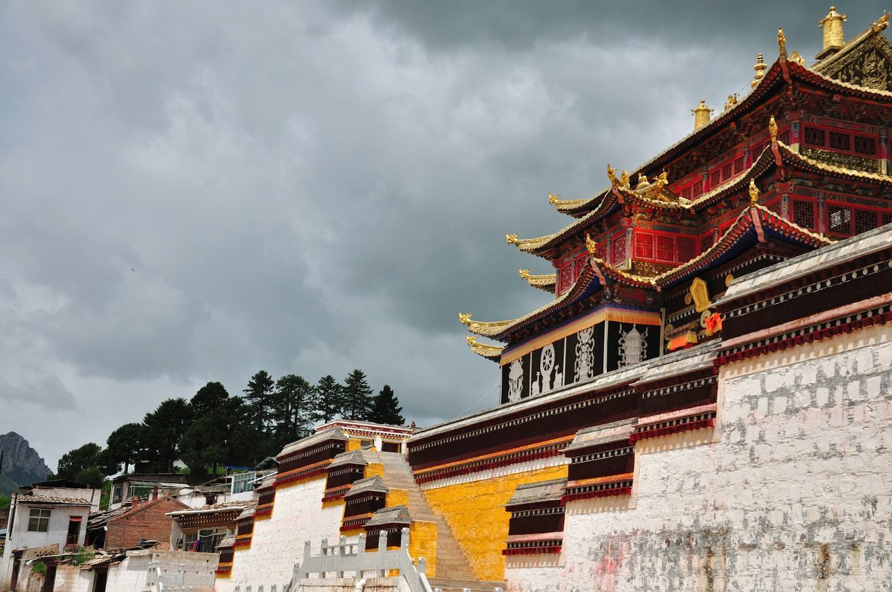 architecture, building exterior, built structure, place of worship, religion, spirituality, temple - building, low angle view, sky, tradition, roof, cultures, cloud - sky, pagoda, famous place, travel destinations, temple, culture, history