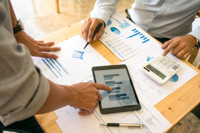 Midsection of business colleagues working at office