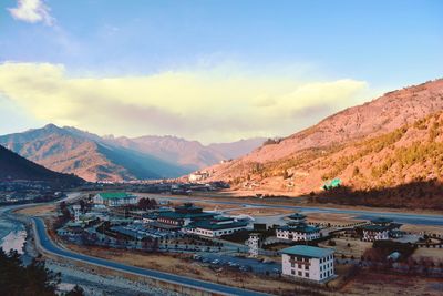 Airport by mountains against sky