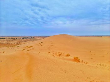 Sand dunes and clouds in sahara desert