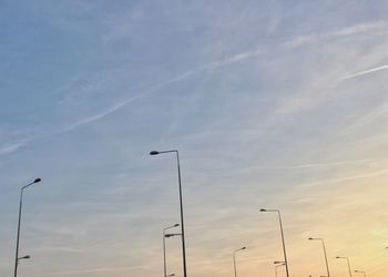 Low angle view of silhouette street light against sky