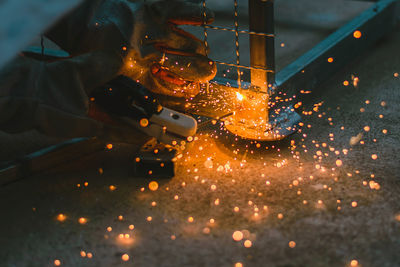 Close-up of cropped hands welding metal