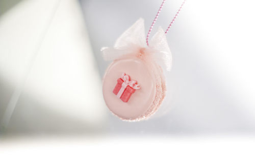 Close-up of macaroon necklace hanging over table