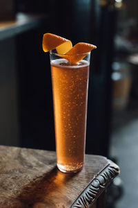 Champagne sparkling wine cocktail with orange twist garnish in minimal flute glasses 