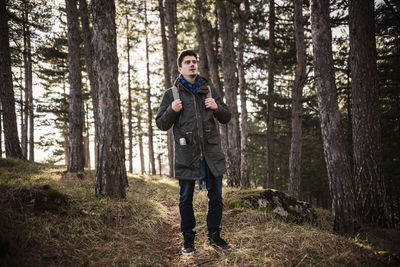 Full length of man standing in forest