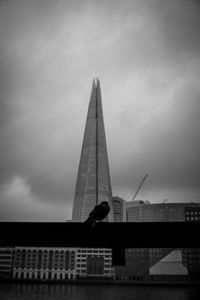 Low angle view of silhouette building against sky