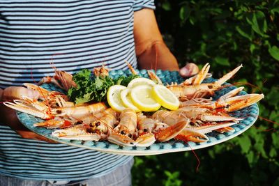 Man serving crayfish at a garden party