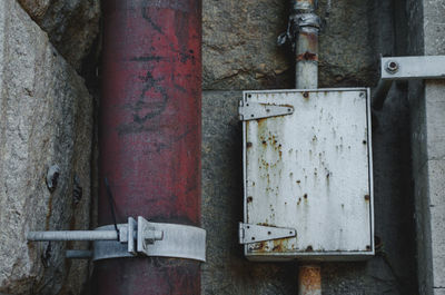 Close-up of old rusty pipe against wall