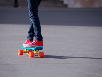 Low section of person skateboarding on footpath