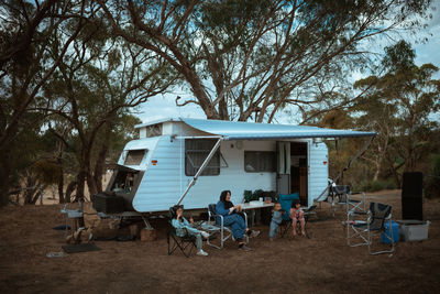 Rear view of people sitting on field