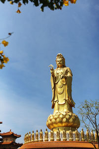 Low angle view of statue against sky