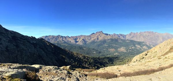 Scenic view of mountains against clear blue sky