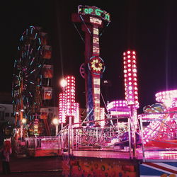 Illuminated ferris wheel at night