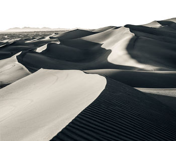 Close-up of sand dune in desert against sky