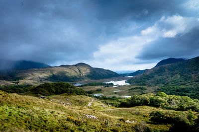 Scenic view of mountains against cloudy sky