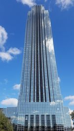 Low angle view of modern building against cloudy sky