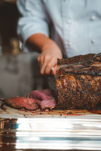 Midsection of man preparing food