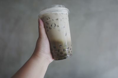 Close-up of hand holding glass of drink