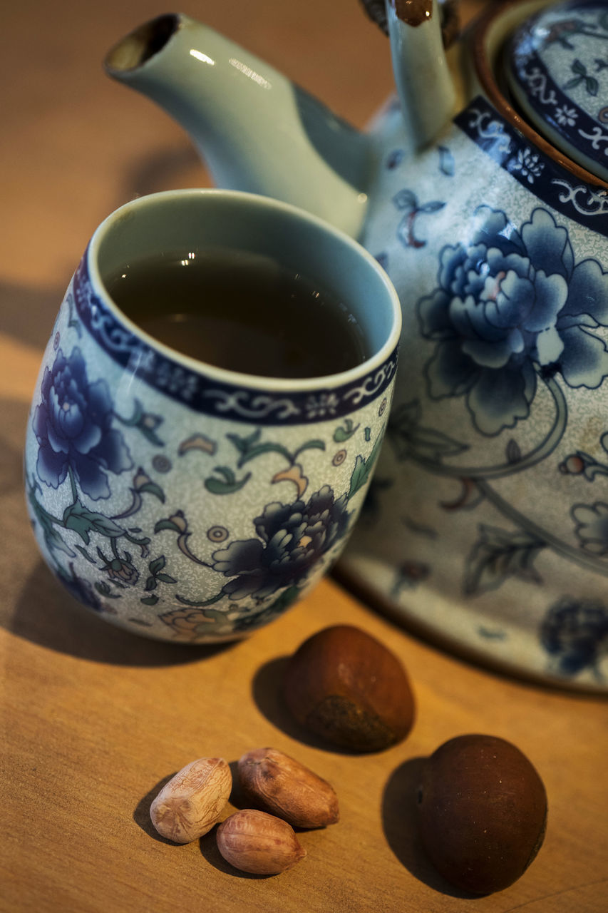 HIGH ANGLE VIEW OF TEA CUP ON TABLE WITH SPOON