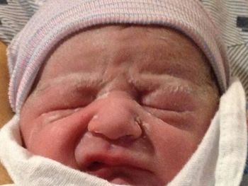 Close-up of baby sleeping on bed