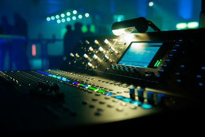 Close-up of sound mixer at night