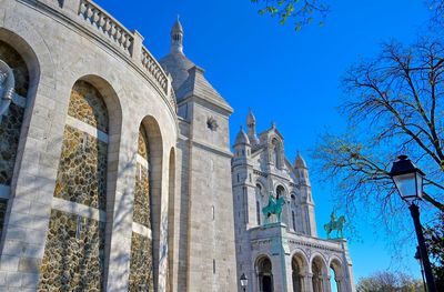 Low angle view of historical building against blue sky