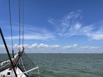 Sailboat sailing in sea against sky