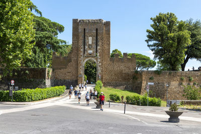 People walking in front of historical building