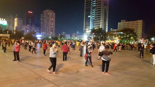People on illuminated city at night