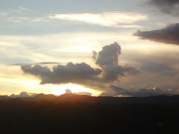 Scenic view of mountains against sky at sunset