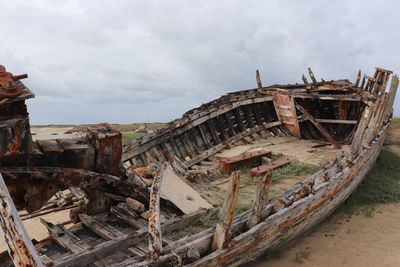 Old rusty ship against sky