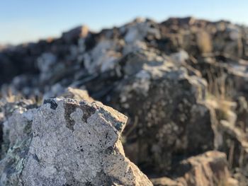 Close-up of rock against sky on sunny day